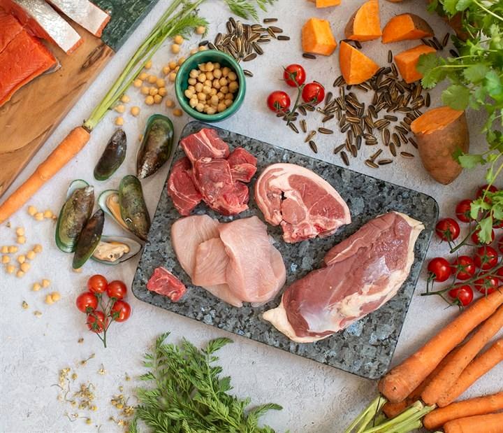 Fresh meat, poultry, seafood and vegetables arranged for premium pet nutrition